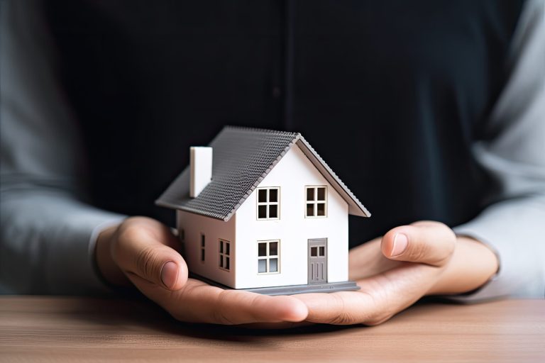 woman showing with one hand a mini house. Real state concept